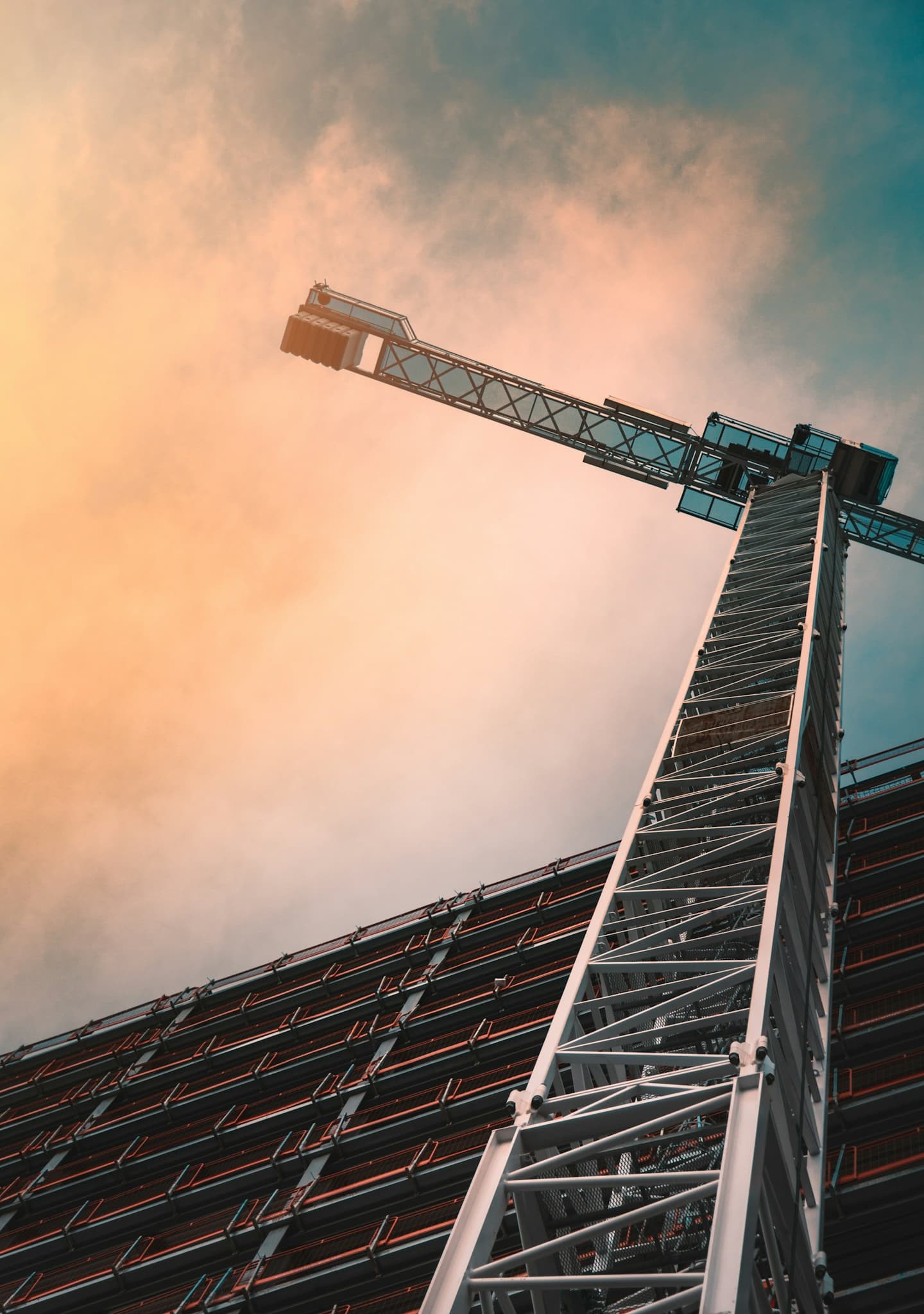 Construction crane against sunset sky